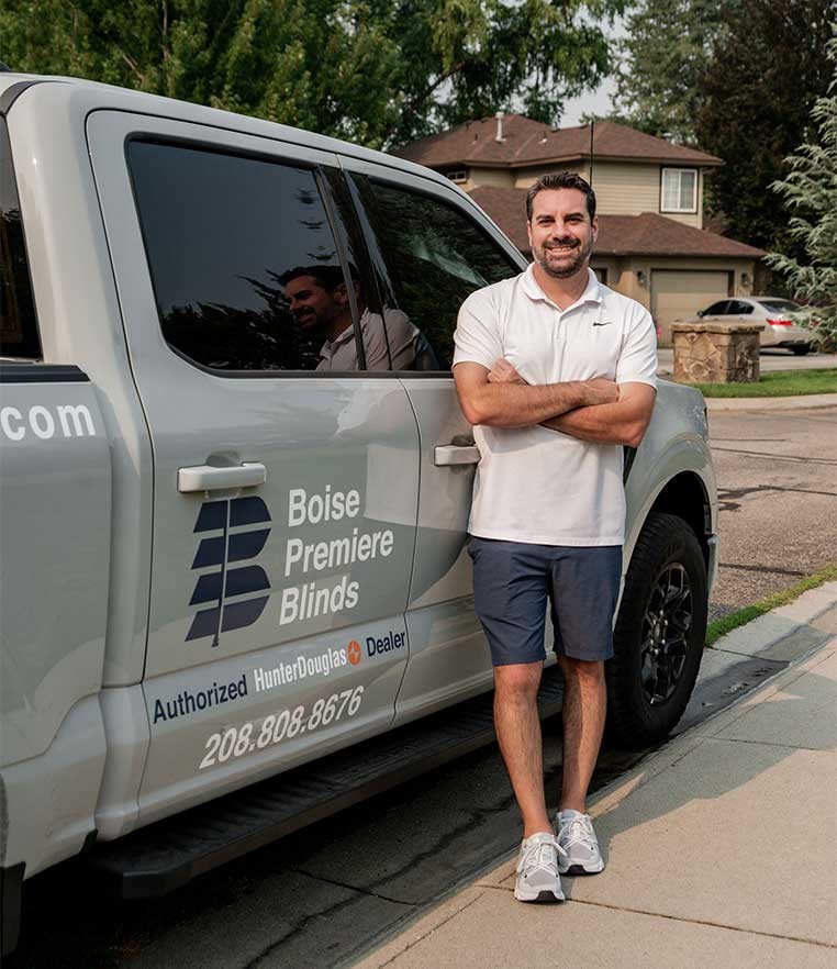 A man posing for a photo with the company truck